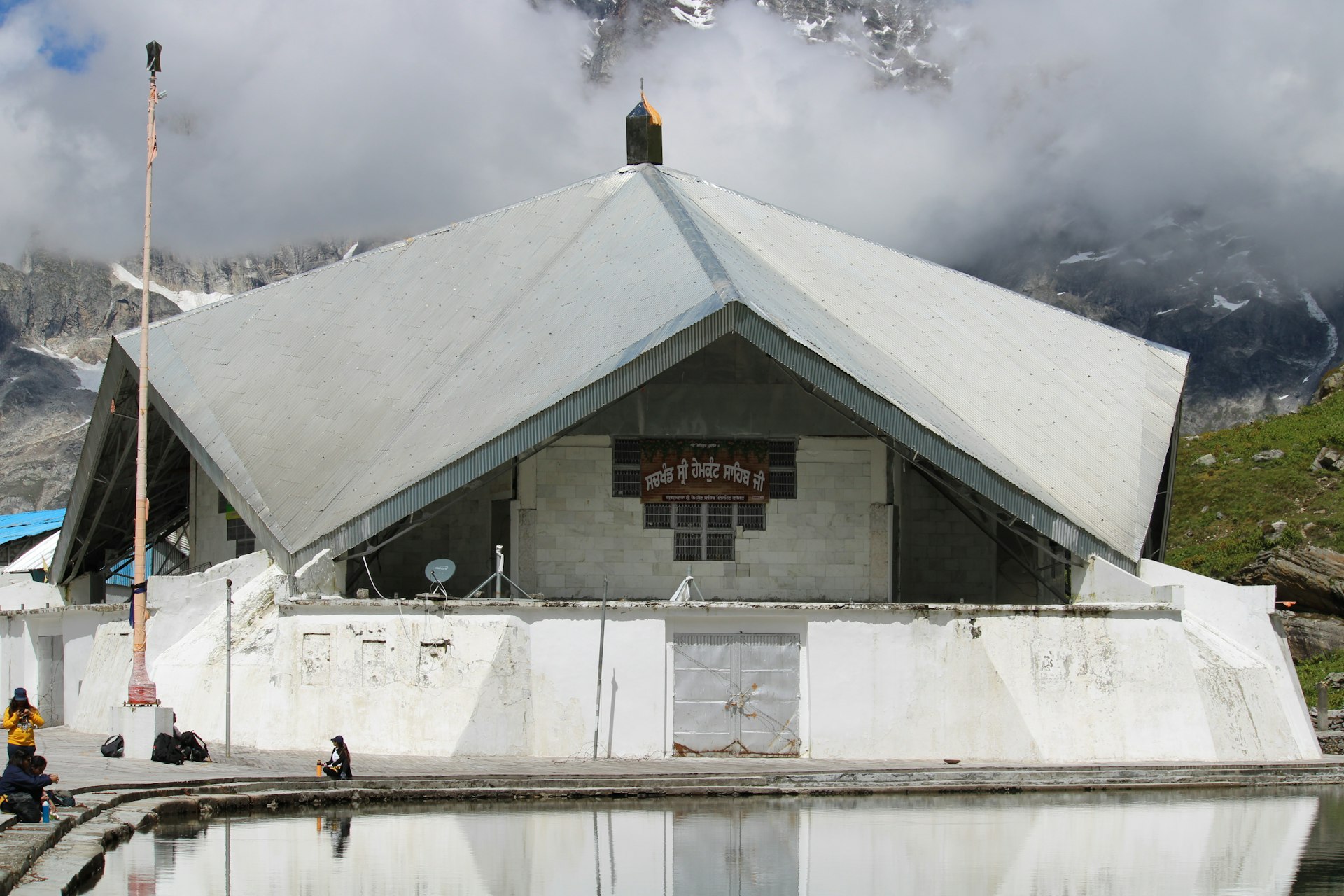 white concrete building under white clouds during daytime